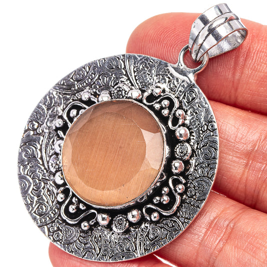 Orange onyx cabochon pendant with ornate German silver frame and bail