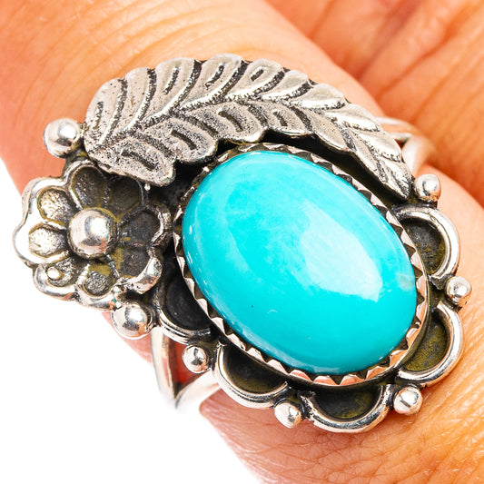 Sterling silver ring with oval turquoise center and leaf-and-flower filigree setting