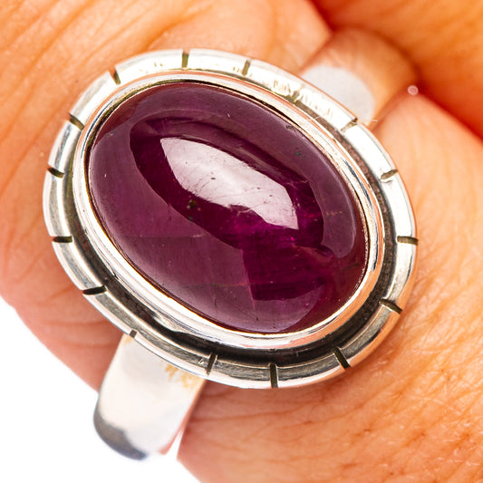 Oval purple ruby cabochon set in sterling silver ring with round bezel