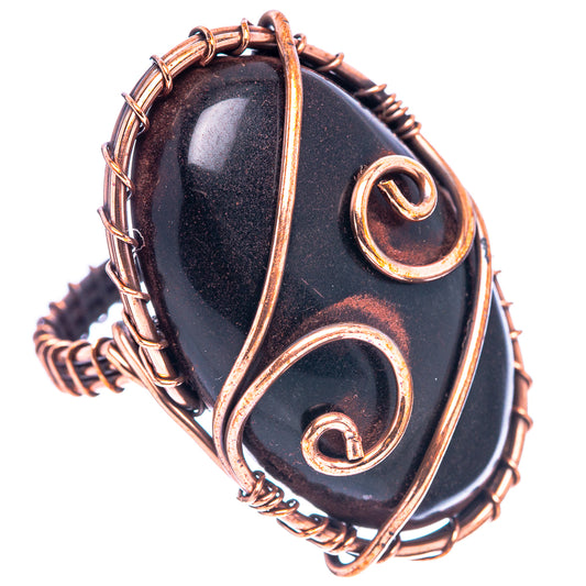Oxidized copper jet-stone ring with oval black cabochon and swirling wire bezel