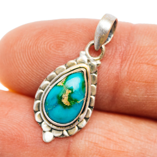 Sterling silver teardrop turquoise pendant with ornate bezel and stone cabochon