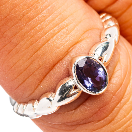 Sterling silver ring with oval blue iolite gemstone on tapered scalloped band
