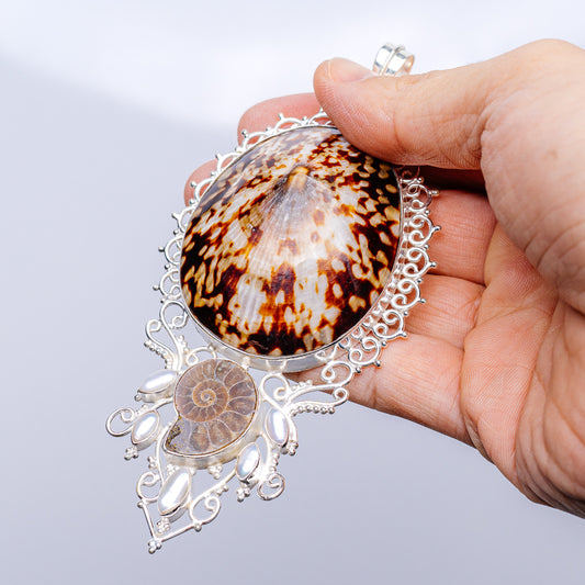 Sterling silver fossil pendant with oval brown-orange shell, pearl drops and filigree frame