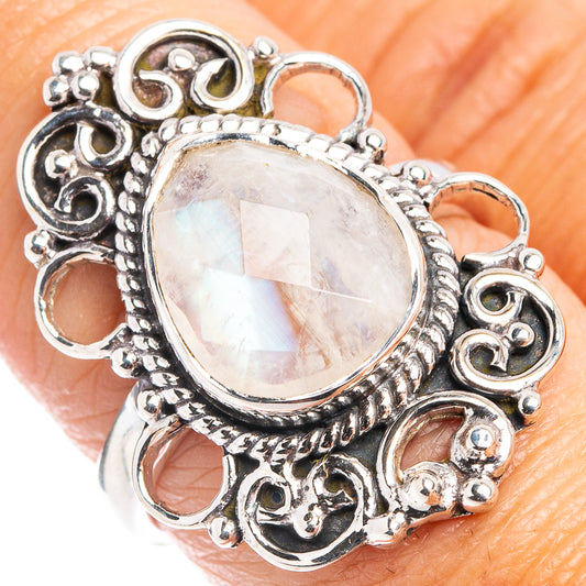 Sterling silver moonstone ring with pear-cut iridescent stone and ornate halo setting