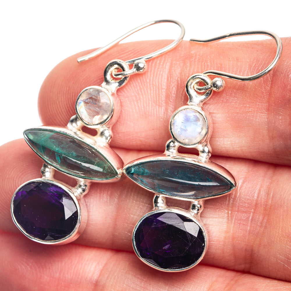 Sterling silver drop earrings with iridescent white, teal, and purple oval gemstones