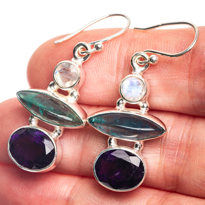 Sterling silver drop earrings with iridescent white, teal, and purple oval gemstones