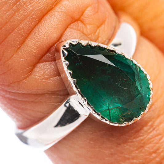 Sterling silver ring with oval dark green faceted emerald and scalloped prong setting