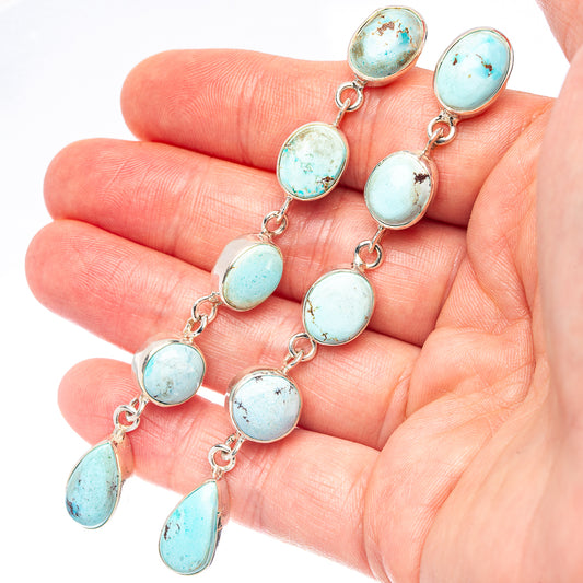Turquoise oval stone drop earrings with silver chain links and oval danglers