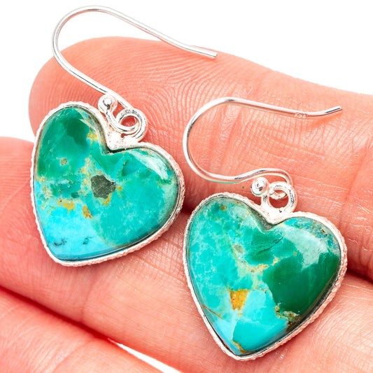 Turquoise heart earrings on silver hooks, bezel-set turquoise stone hearts detail.