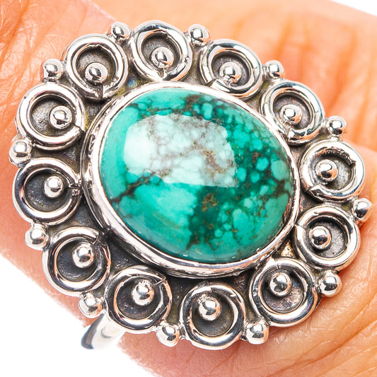 Oval turquoise cabochon sterling silver ring with beaded halo setting, close-up