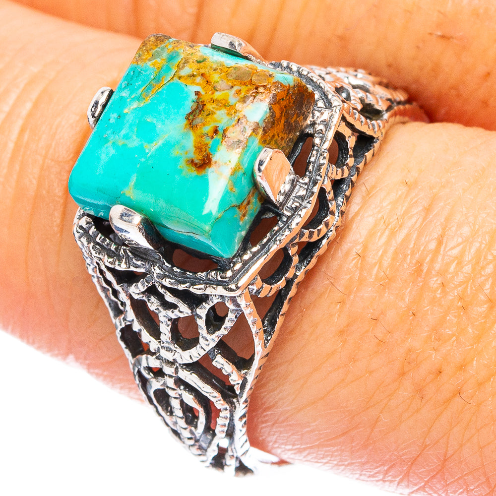 Turquoise stone silver ring with ornate cutout design, square bezel setting