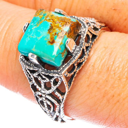 Turquoise stone silver ring with ornate cutout design, square bezel setting