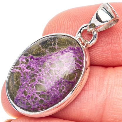 Oval stichtite pendant in sterling silver bezel with purple stone, close-up bail