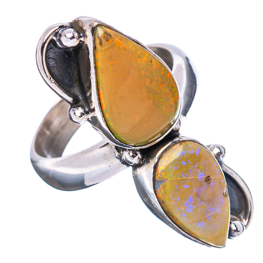 Sterling silver opal ring viewed from the side, featuring two yellow oval opal stones