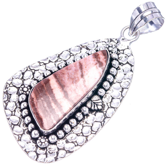 Oval coconut jasper pendant with textured border and loop bail in silver tone