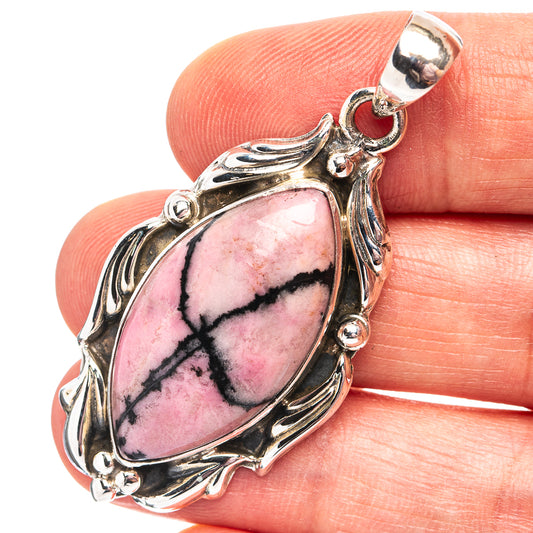 Rhodonite pendant in oval cabochon set in .925 sterling silver with ornate frame