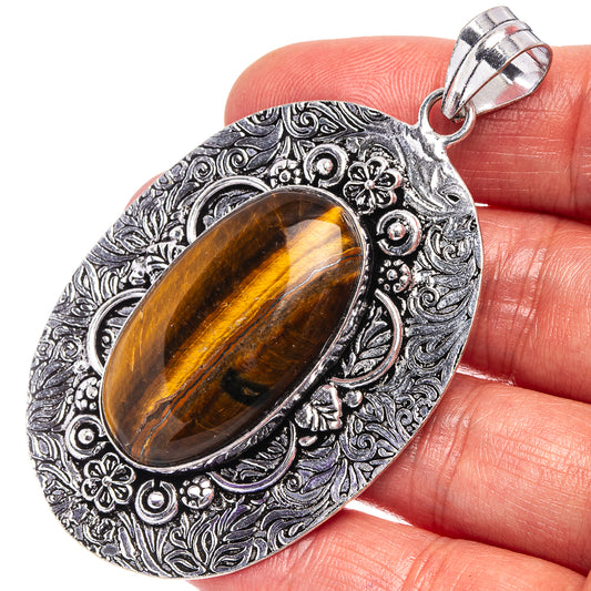 Tiger's eye pendant with oval cabochon in ornate German silver filigree setting