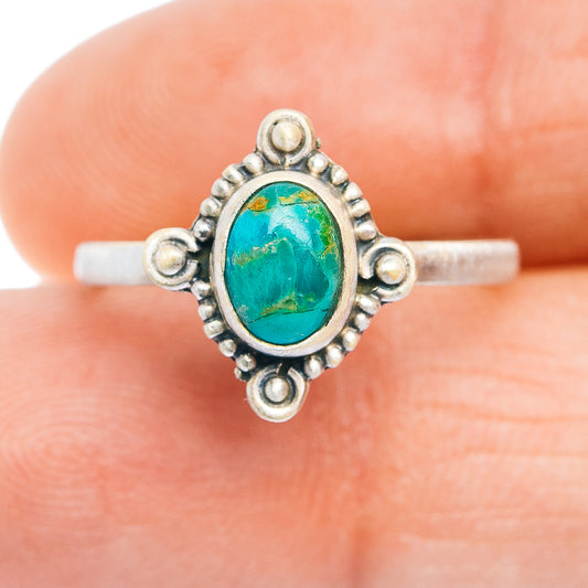 Sterling silver turquoise oval ring with decorative side settings