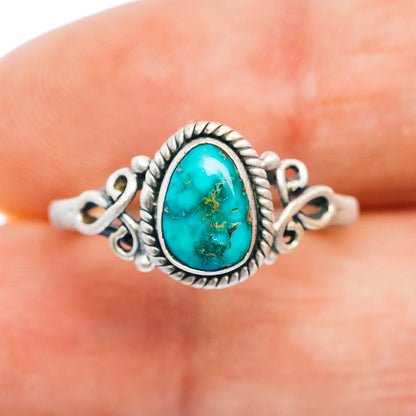 Turquoise oval cabochon sterling silver ring, rope border and side scrolls