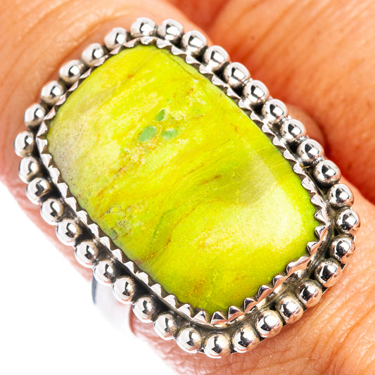 Sterling silver ring close-up, oval green gemstone with scalloped edge and bead border