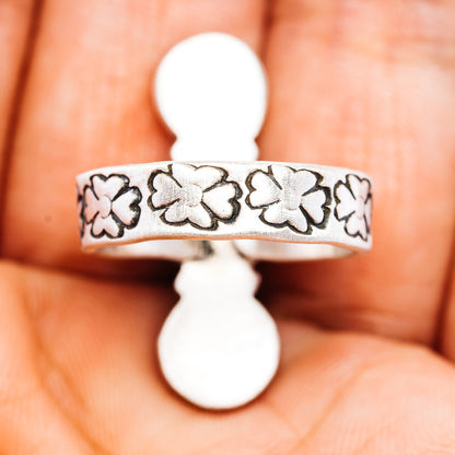 Sterling silver ring band with engraved clover pattern and prong-set yellow stones
