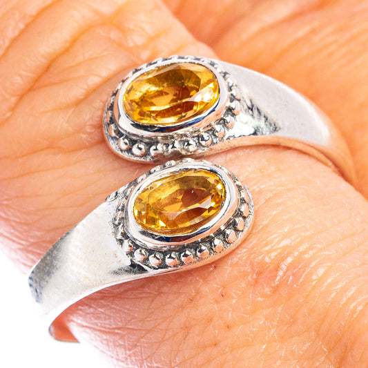 Citrine ring on hand: oval amber stones in ornate .925 sterling silver settings