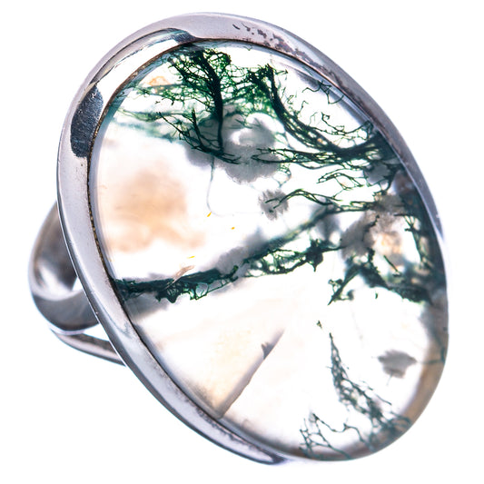 Sterling silver ring with oval green moss agate cabochon, bright reflective surface and veins.