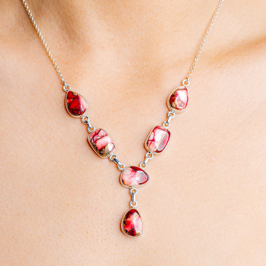 Sterling silver necklace with red oval gemstones and teardrop pendant
