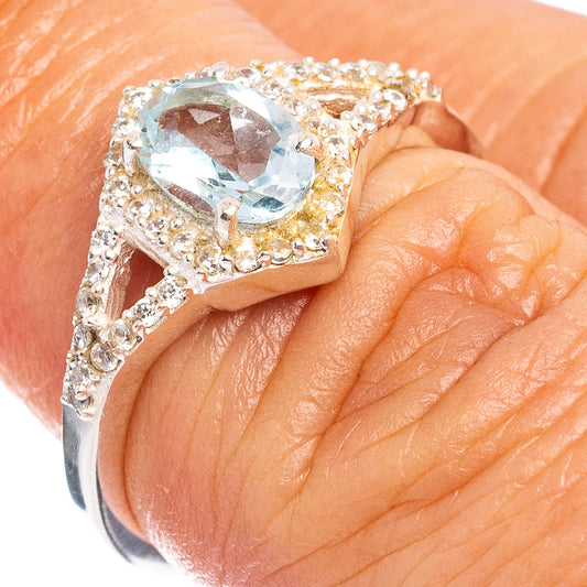 Sterling silver ring with round blue topaz center and cubic zirconia halo, size 5.75