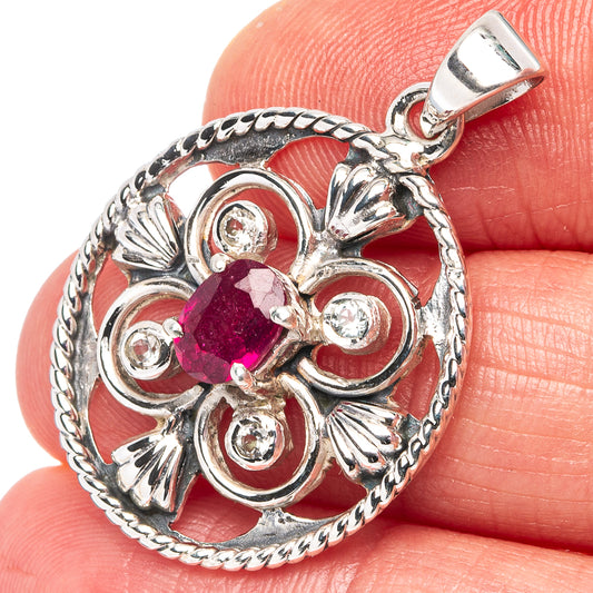Sterling silver ruby pendant with oval pink ruby and decorative round clear stones