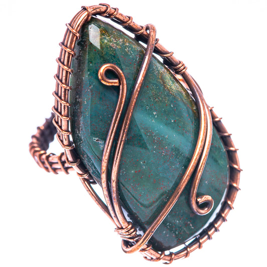 Oxidized copper wire ring with dark green teardrop stone and looping swirl bezel