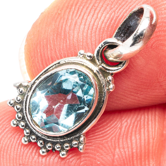 Blue topaz oval pendant with ornate .925 sterling silver frame and bail