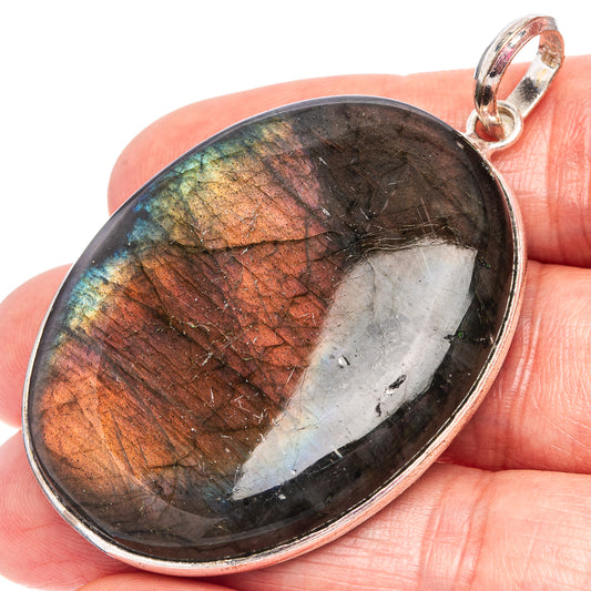 Silver-plated oval labradorite pendant with iridescent multicolor stone and loop bail.