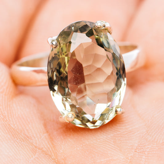 Sterling silver oval gemstone ring, faceted pale green with four small prongs