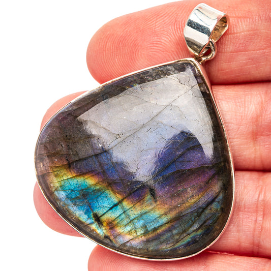 Teardrop labradorite pendant with iridescent blue-purple flashes and silver bail.