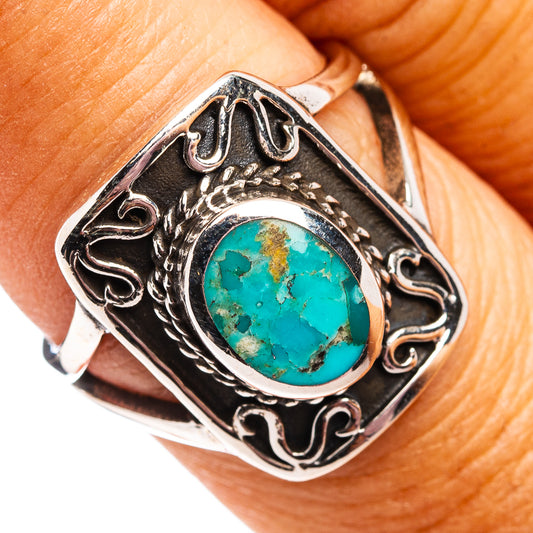 Sterling silver turquoise cabochon ring with ornate bezel and scrollwork
