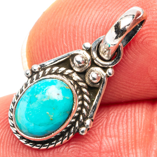 Turquoise oval pendant with ornate .925 sterling silver frame and top loop