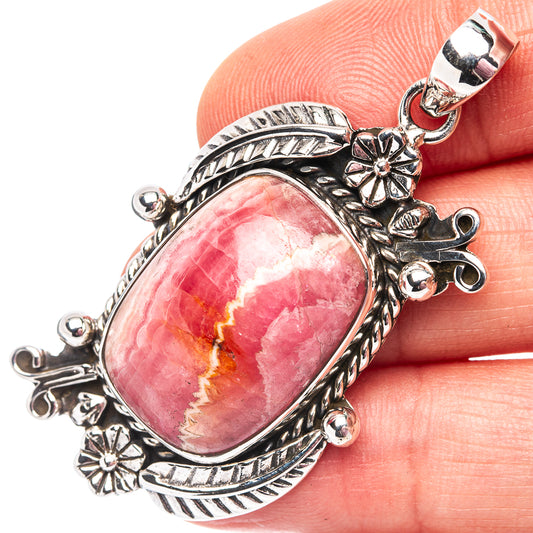 Close-up oval pink rhodochrosite pendant, .925 sterling silver with flower bezel