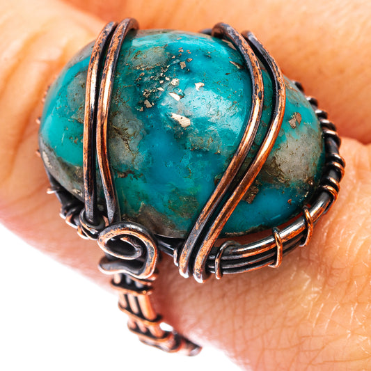 Oxidized copper wire wrap ring with turquoise oval stone, close-up detail