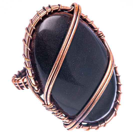 Oval black jet ring with oxidized copper wire wrap band, side view