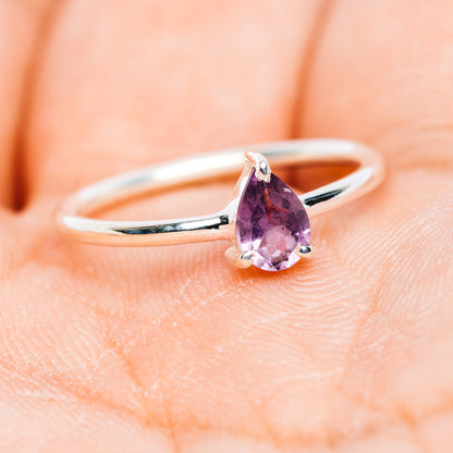 Polished sterling silver ring with pear-shaped amethyst center stone