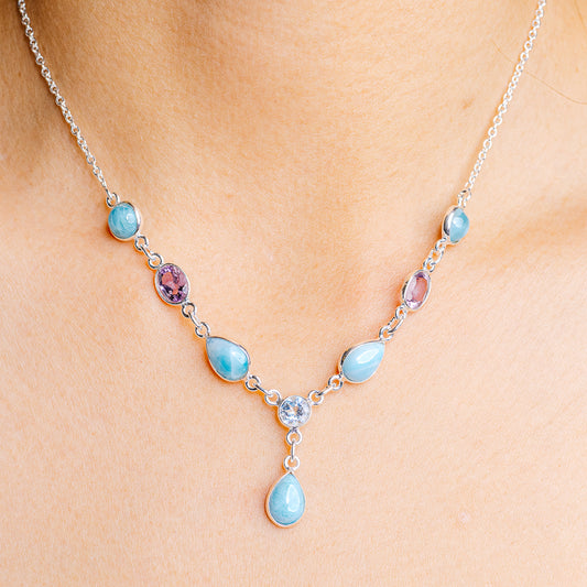 Sterling silver necklace with blue teardrop and purple oval gemstones and small accents
