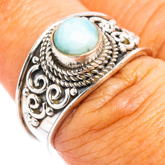 Oval aqua-blue larimar centerpiece on sterling silver cocktail ring with detailed scrollwork