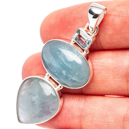 Sterling silver pendant with two oval blue gemstones in bezel settings