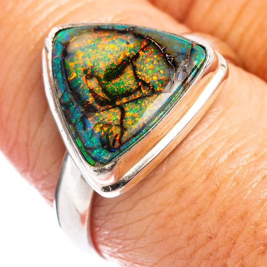 Sterling silver opal ring with triangular bezel, green-orange fire pattern center.