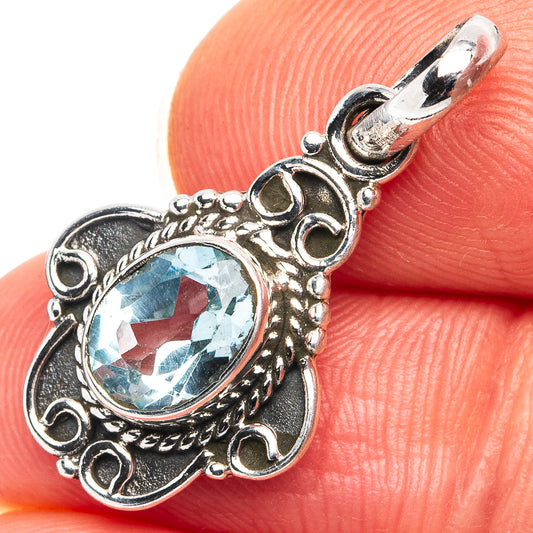Blue topaz pendant in .925 sterling silver, oval blue stone with ornate round setting