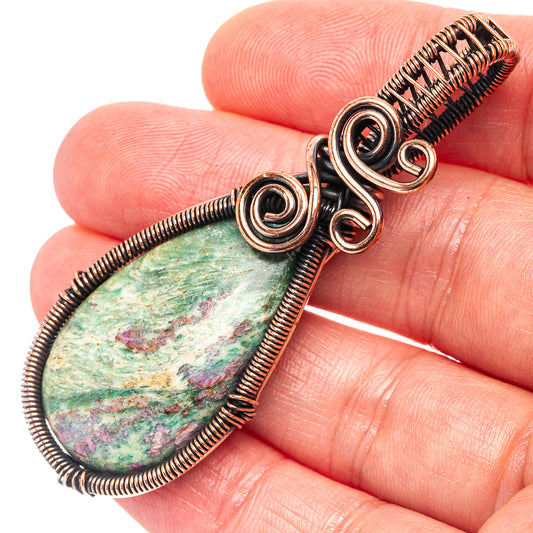 Oxidized copper wire-wrapped teardrop pendant with green fuchsite stone and spiral wraps