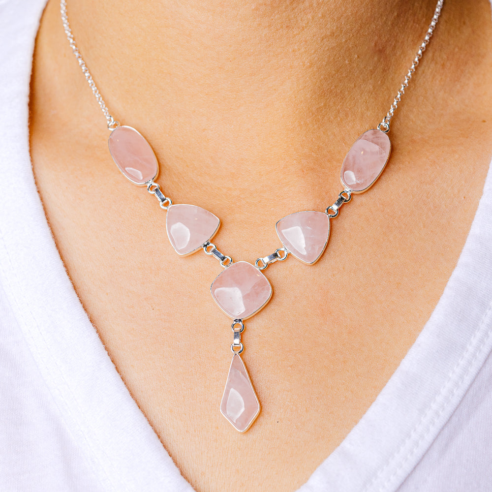 Rose quartz stone pendant necklace on silver chain with five teardrop links