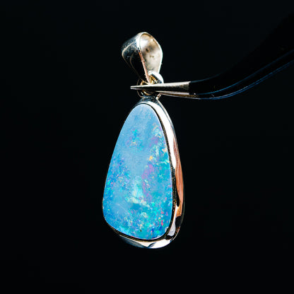 Sterling silver fire opal teardrop pendant with vivid blue opal bezel setting