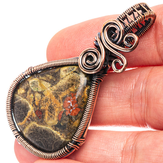 Oxidized copper wire-wrapped pendant with mottled obsidian teardrop and spiral coils
